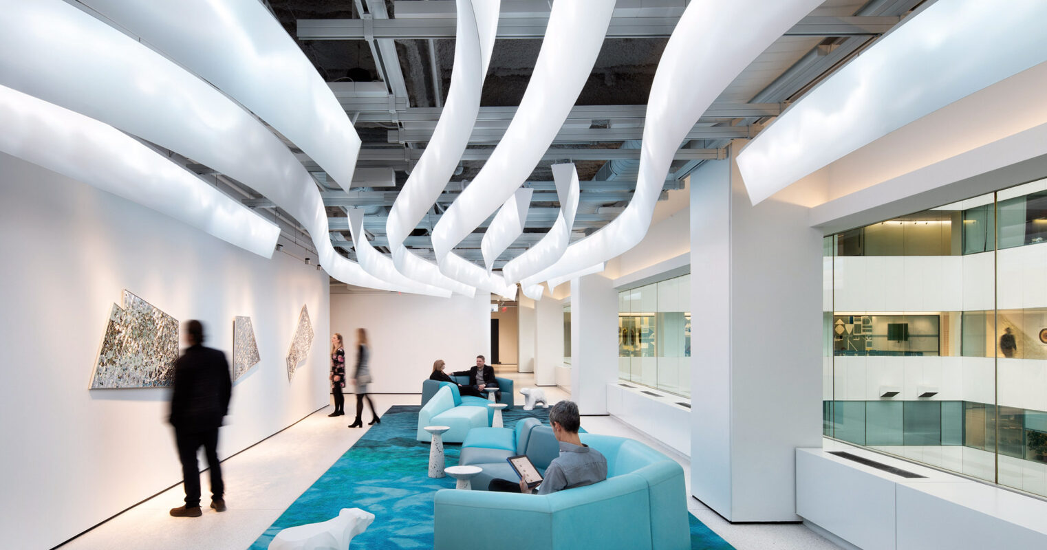 Modern office lobby with futuristic curved lighting fixtures, comfortable seating areas, and abstract art on the walls.